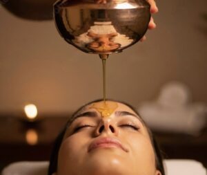 Warm herbal oil poured over the third eye during a Shirodhara treatment at The Soma Spa in Denver