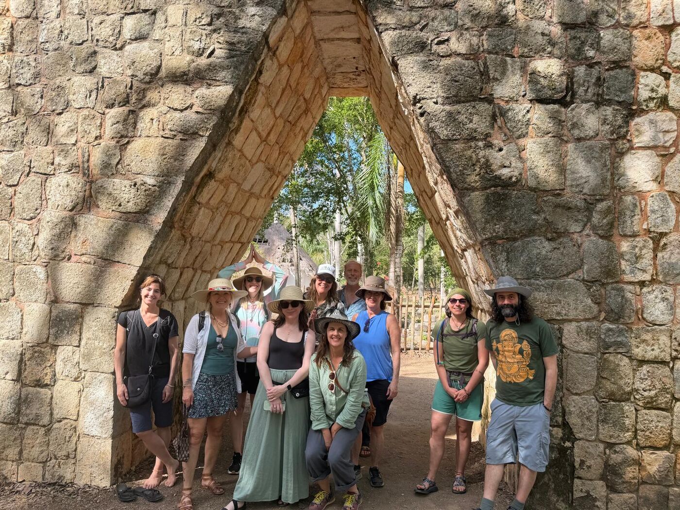 300-hour YTT group beneath a Mayan arch in the Yucatán