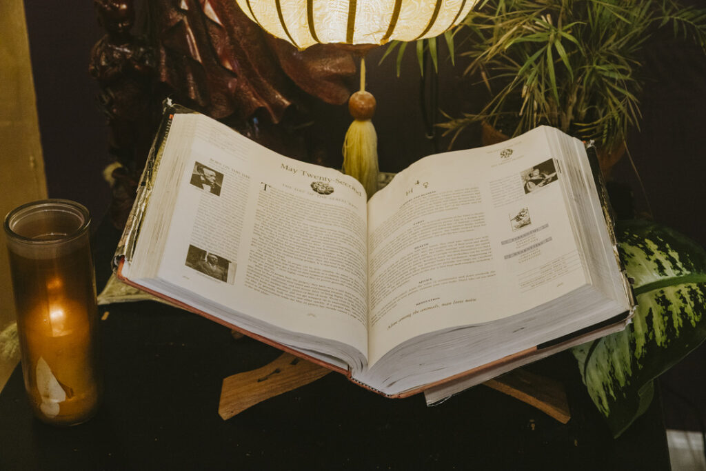 Open astrology book by lantern light at Karma Yoga Center