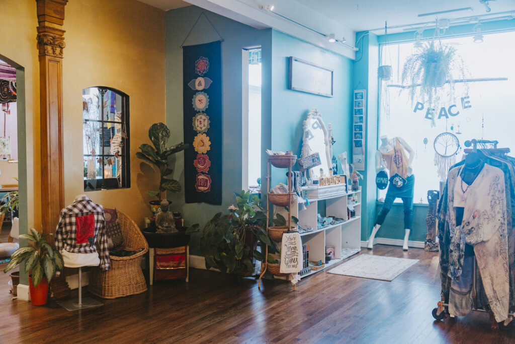 Boutique clothing, jewelry, and gifts by the front window at Karma Yoga Center