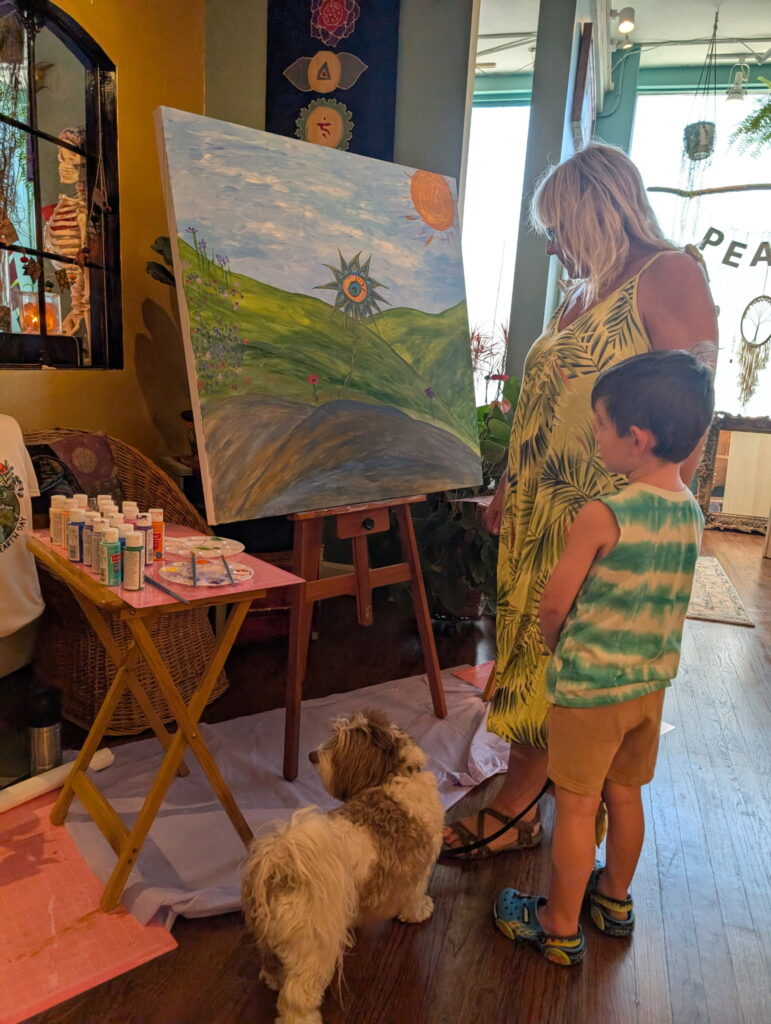 Family and friends at a community painting event at Karma Yoga Center
