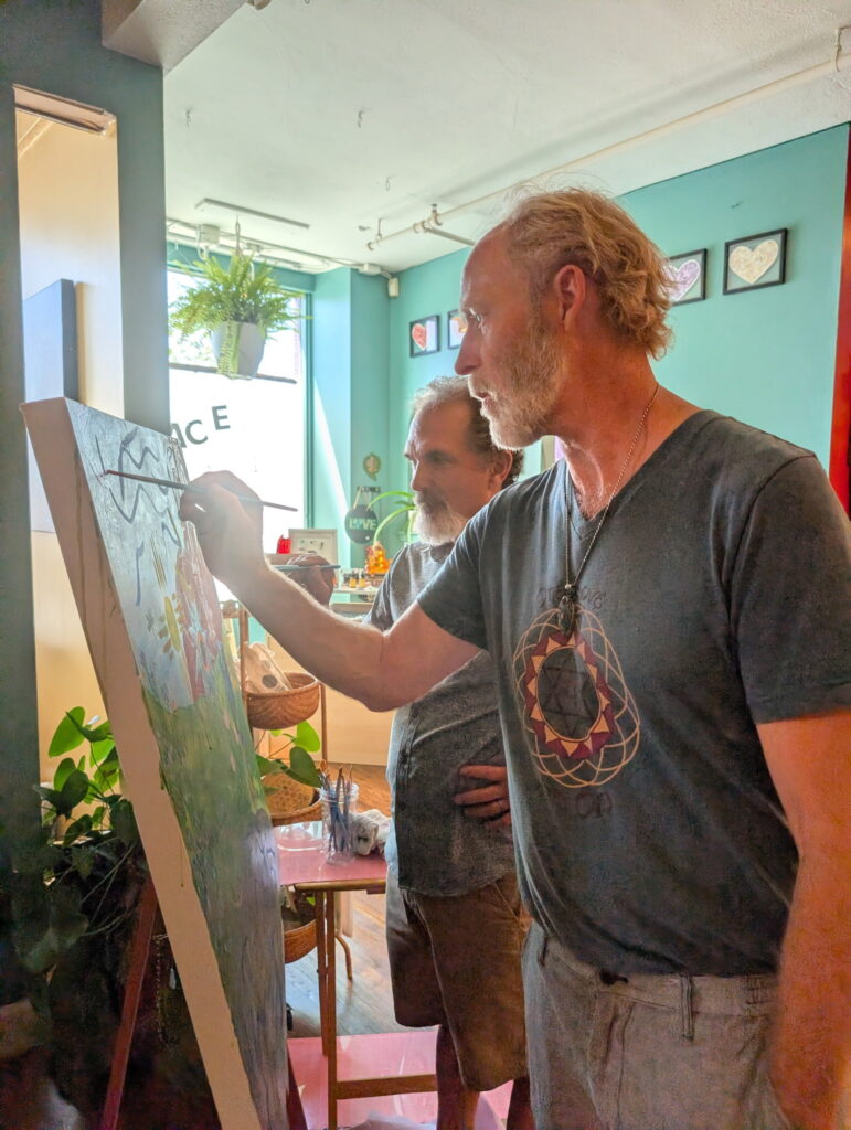 Community members painting together at Karma Yoga Center
