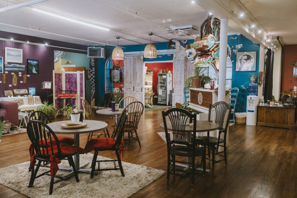 Community gathering area with café tables at Karma Yoga Center