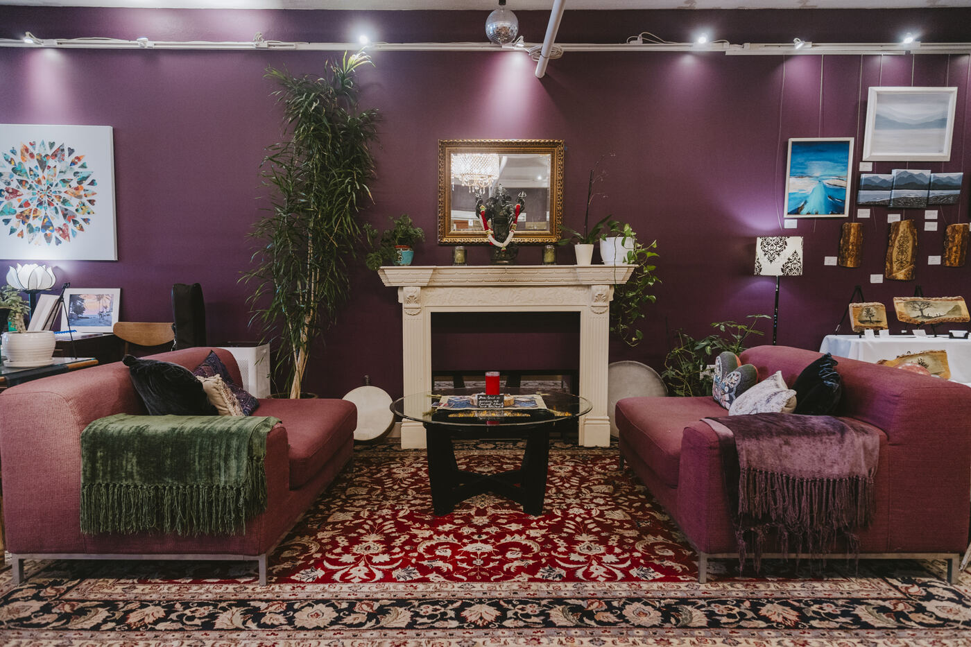 Community lounge with fireplace and couches at Karma Yoga Center