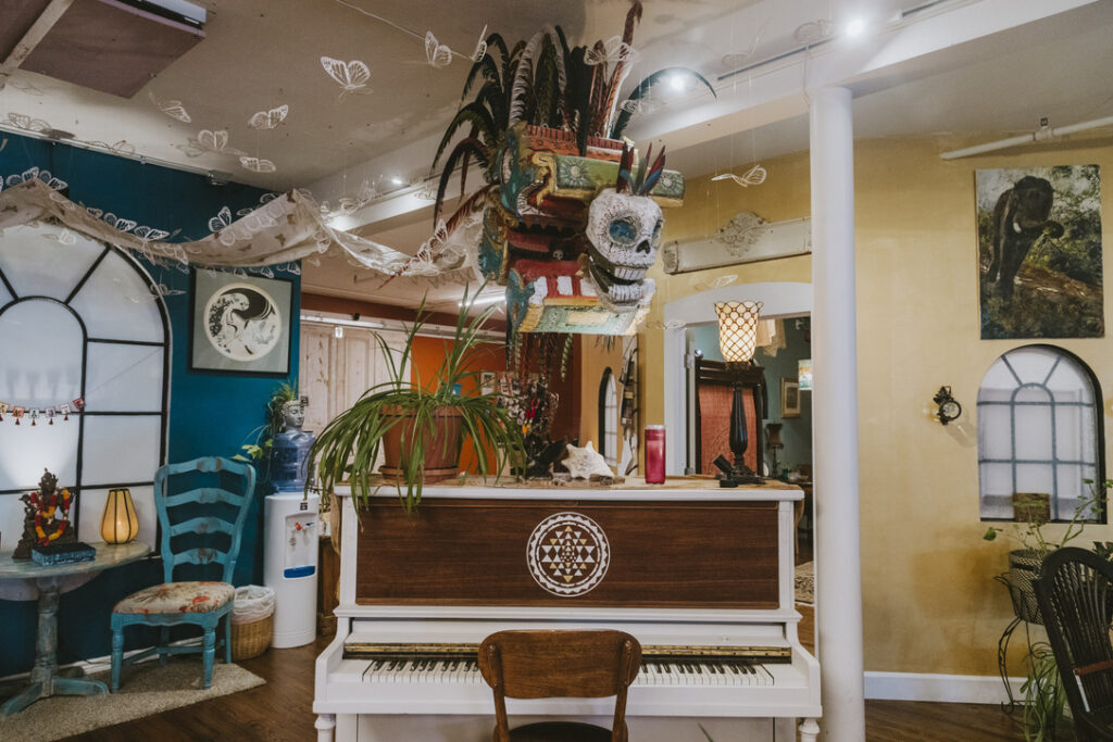Piano and artwork in the community gathering space at Karma Yoga Center