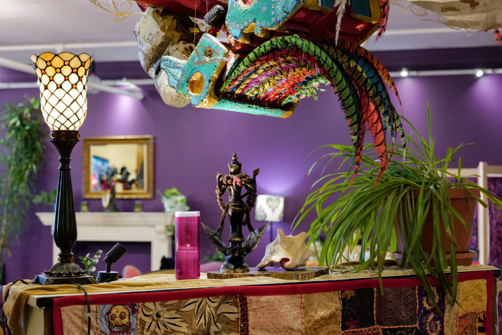Community space altar with Tiffany lamp and conch at Karma Yoga Center
