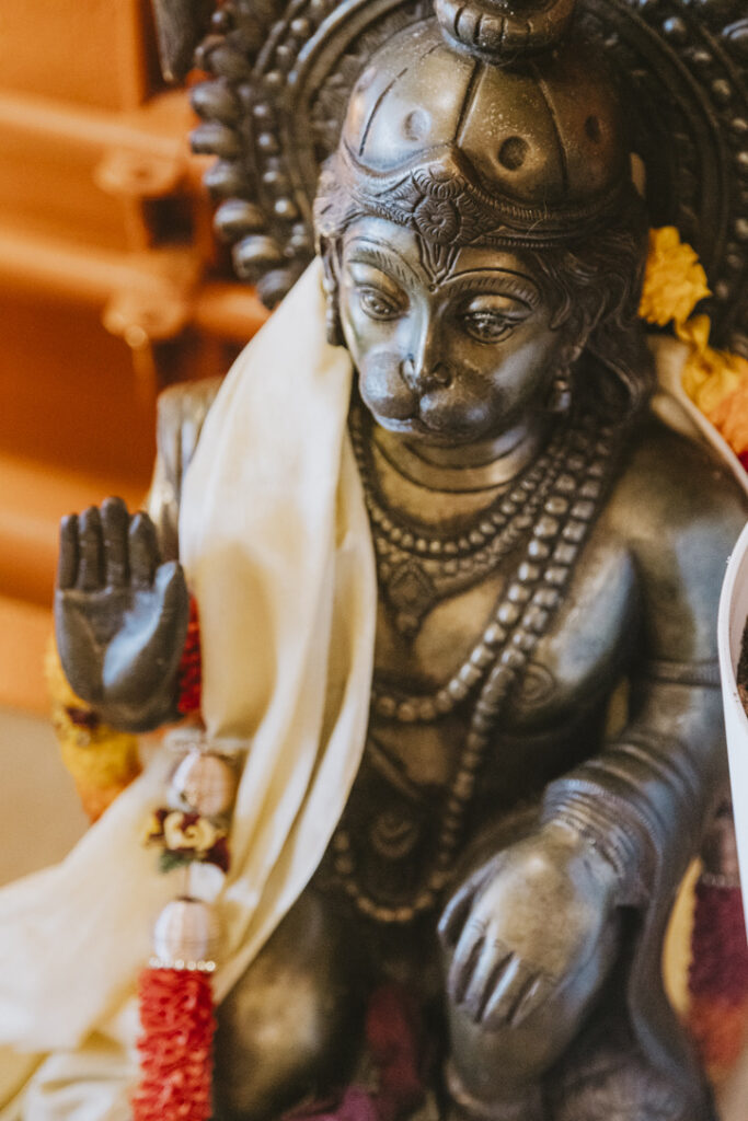 Hanuman statue with garland at Karma Yoga Center