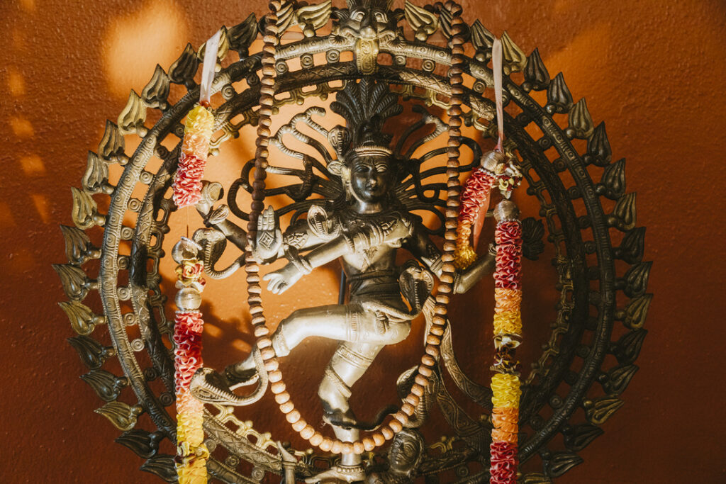 Nataraja, dancing Shiva, with flower garlands at Karma Yoga Center