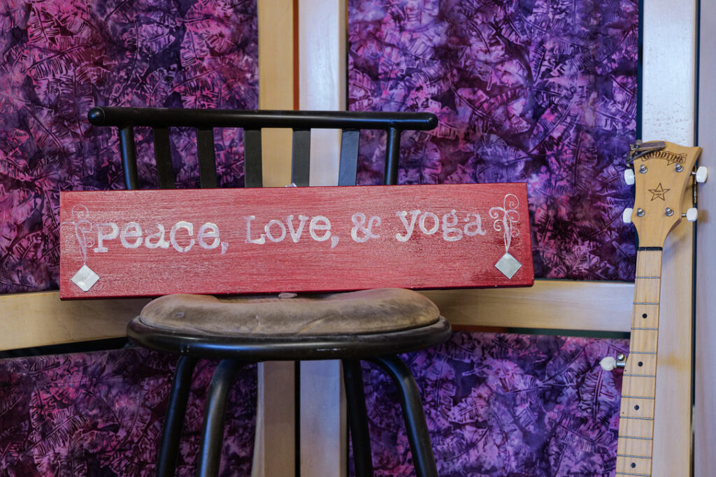 Peace, Love & Yoga sign and banjo at Karma Yoga Center