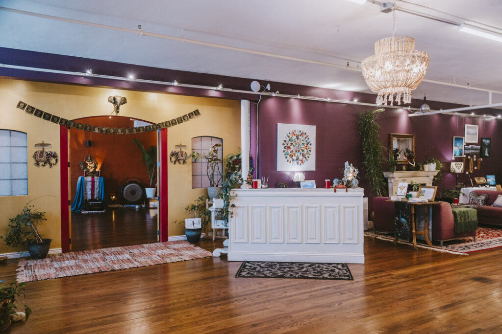 Front desk check-in and entrance to the main studio at Karma Yoga Center, Denver