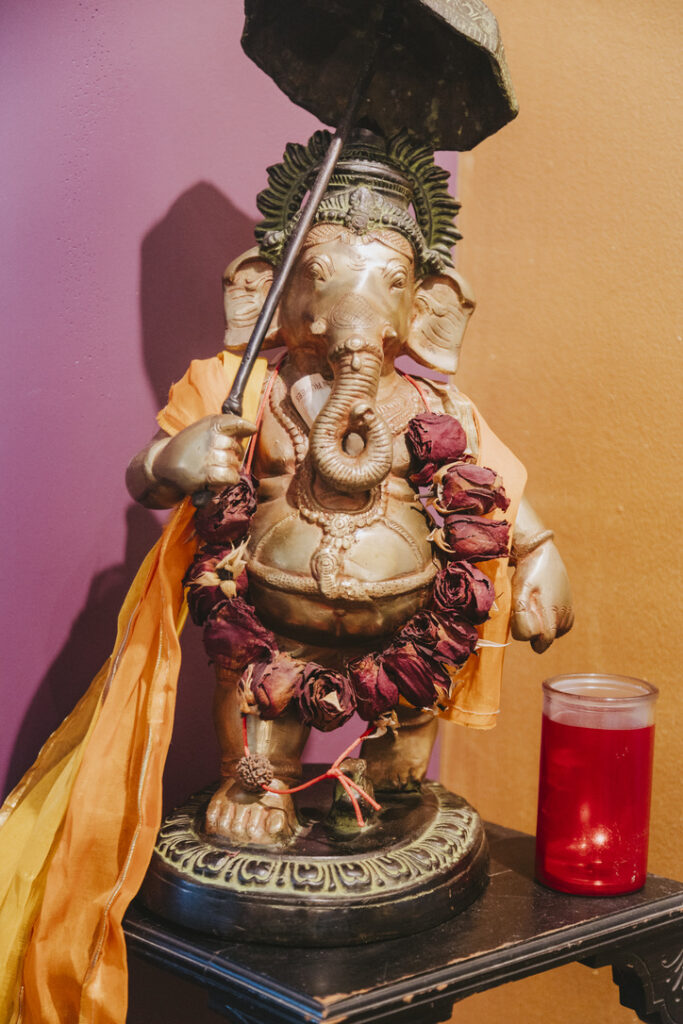 Ganesha statue with rose garland at Karma Yoga Center