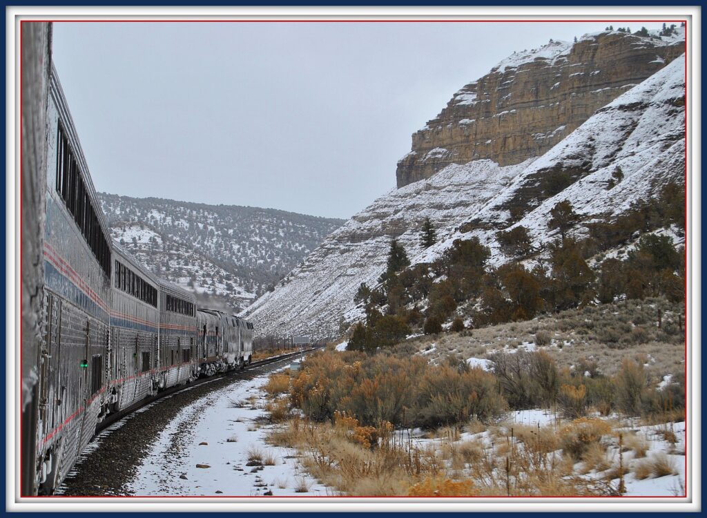 Amtrak California Zephyr winding through snowy Glenwood Canyon