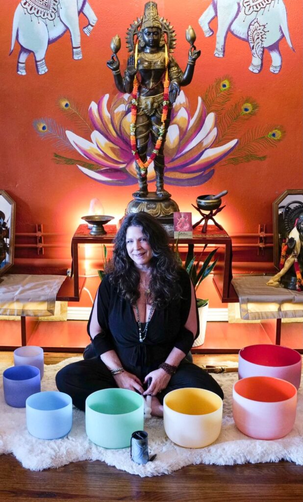 Katrina Gustafson with crystal singing bowls at the altar, Karma Yoga Center, Denver