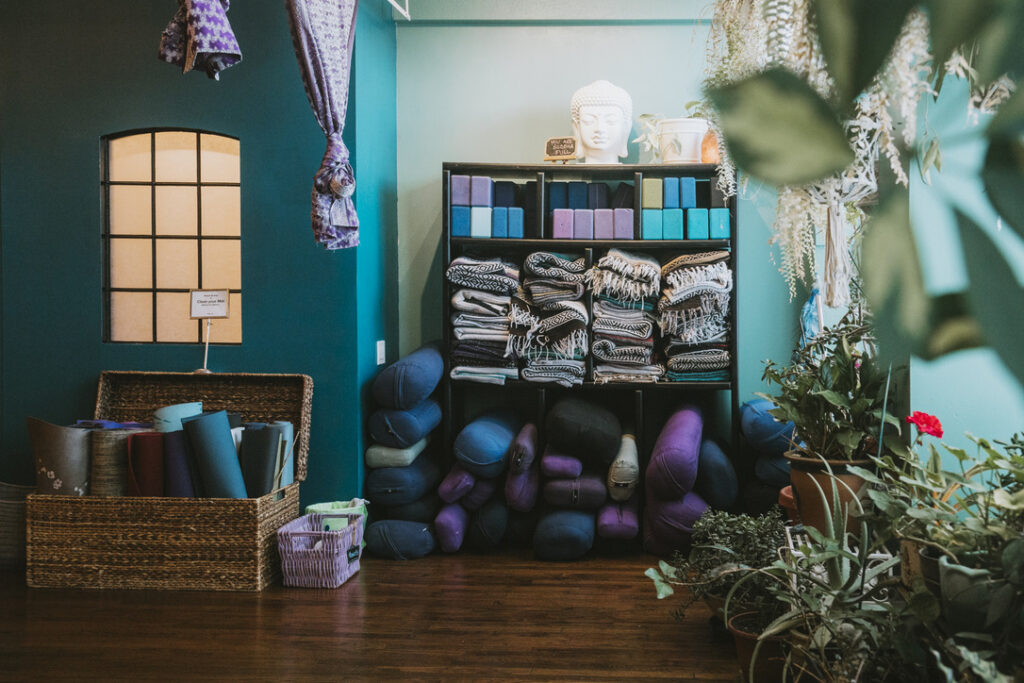 Mats, blocks, bolsters, and blankets provided in the main studio at Karma Yoga Center