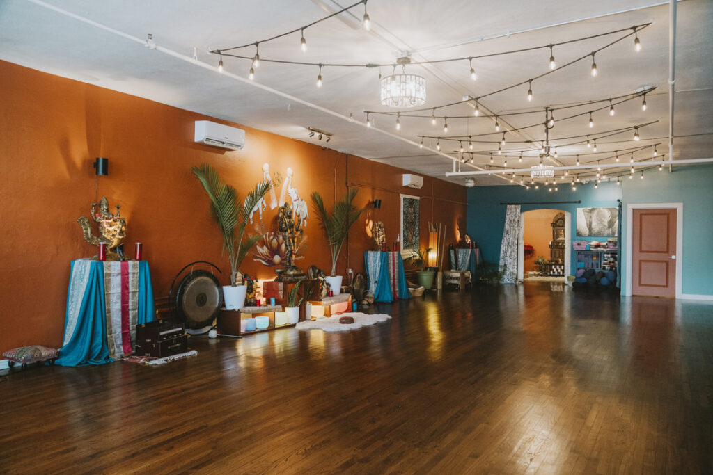 Main studio wood floors and altars at Karma Yoga Center, 1760 S. Broadway