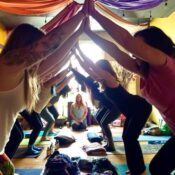Partner yoga at a Karma Yoga Center community class Partner yoga at a Karma Yoga Center community class