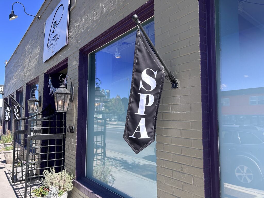 Spa, Yoga, and Art flags on the Karma Yoga Center storefront, 1760 S. Broadway