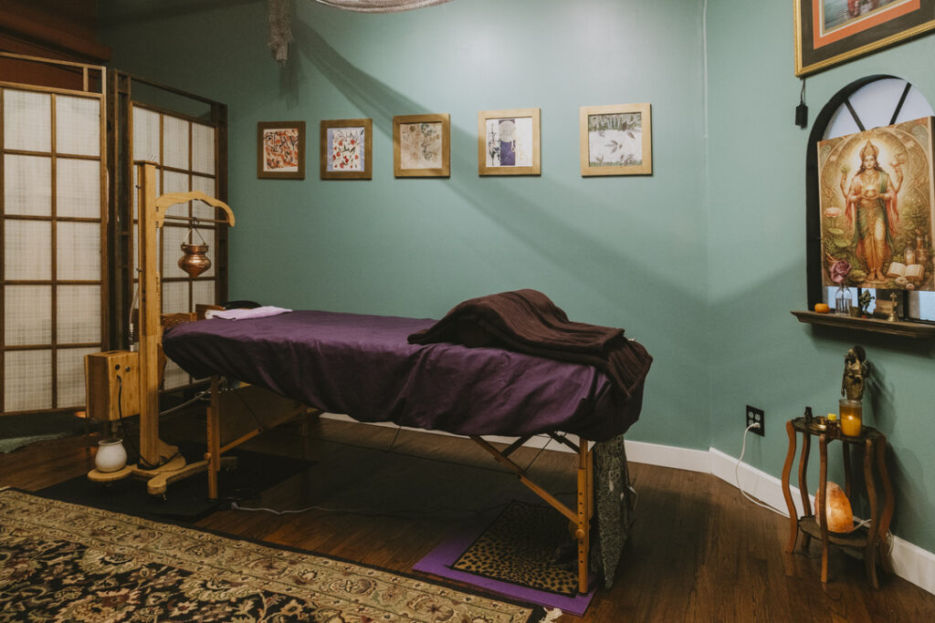 Soma Spa Shirodhara table with goddess art and salt lamp at Karma Yoga Center
