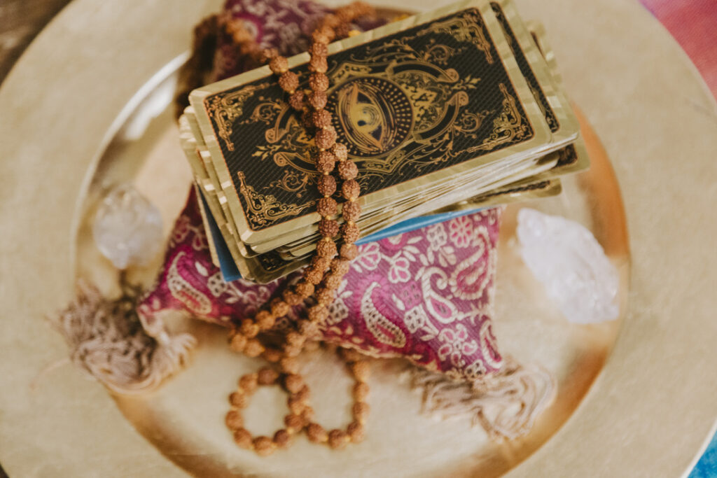 Tarot deck, rudraksha mala, and crystals at Karma Yoga Center