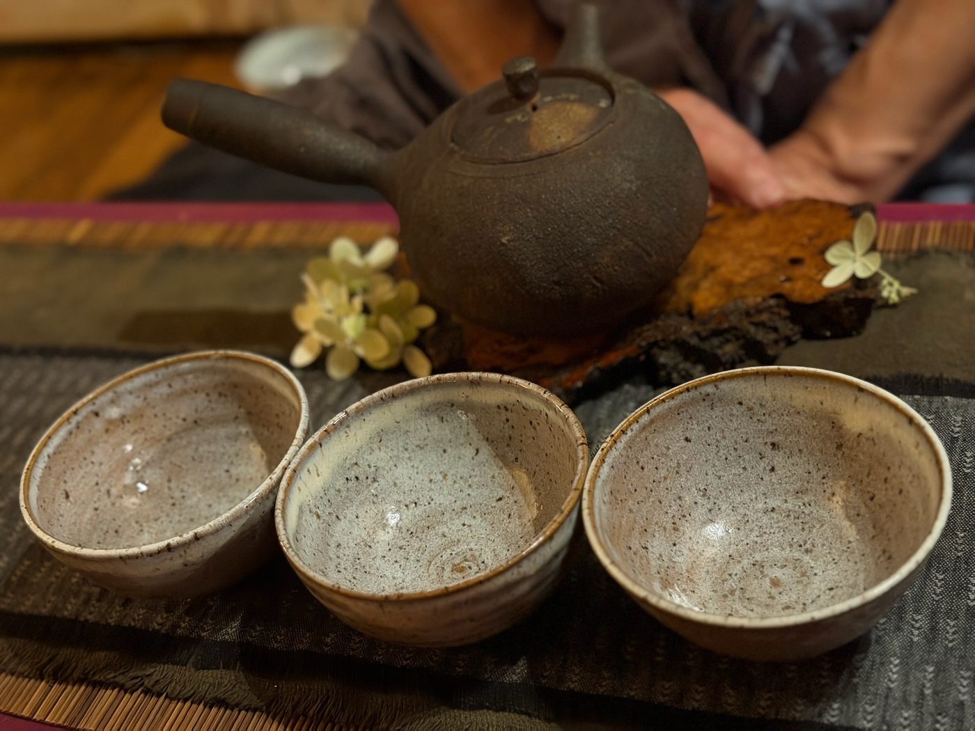 Handmade pottery tea bowls and clay kettle on the tea table at Karma Yoga Center, Denver