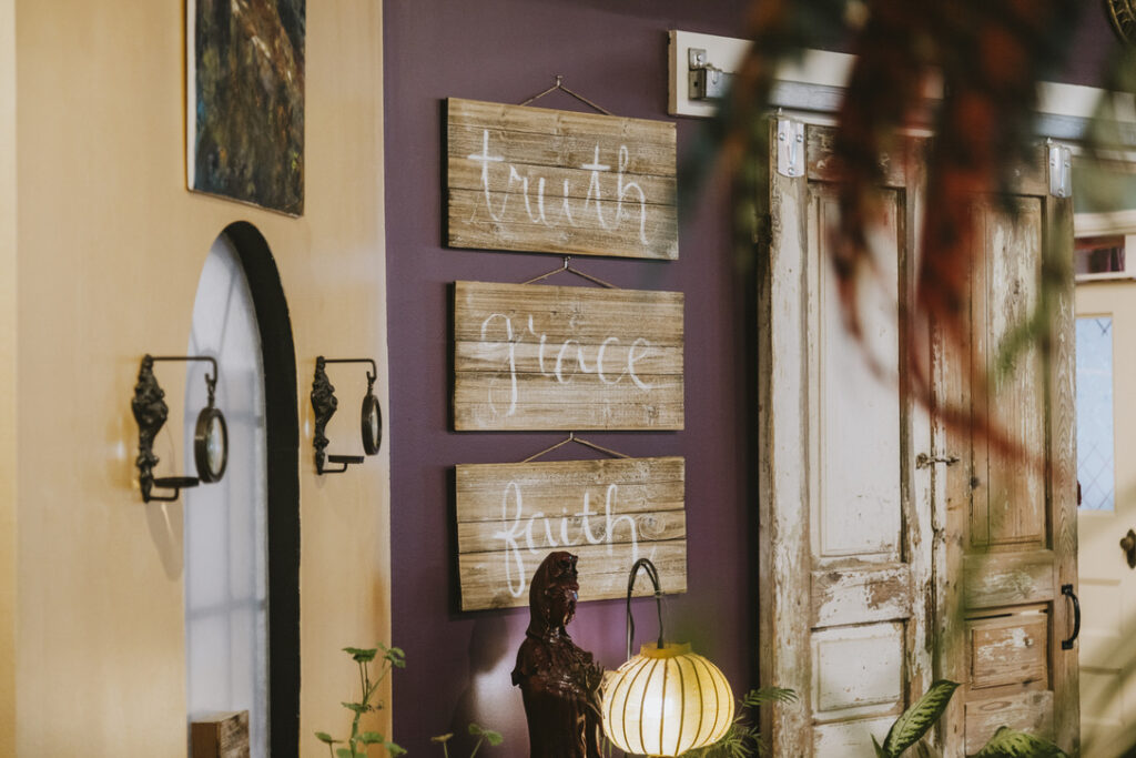 Truth, grace, and faith signs beside the barn doors at Karma Yoga Center