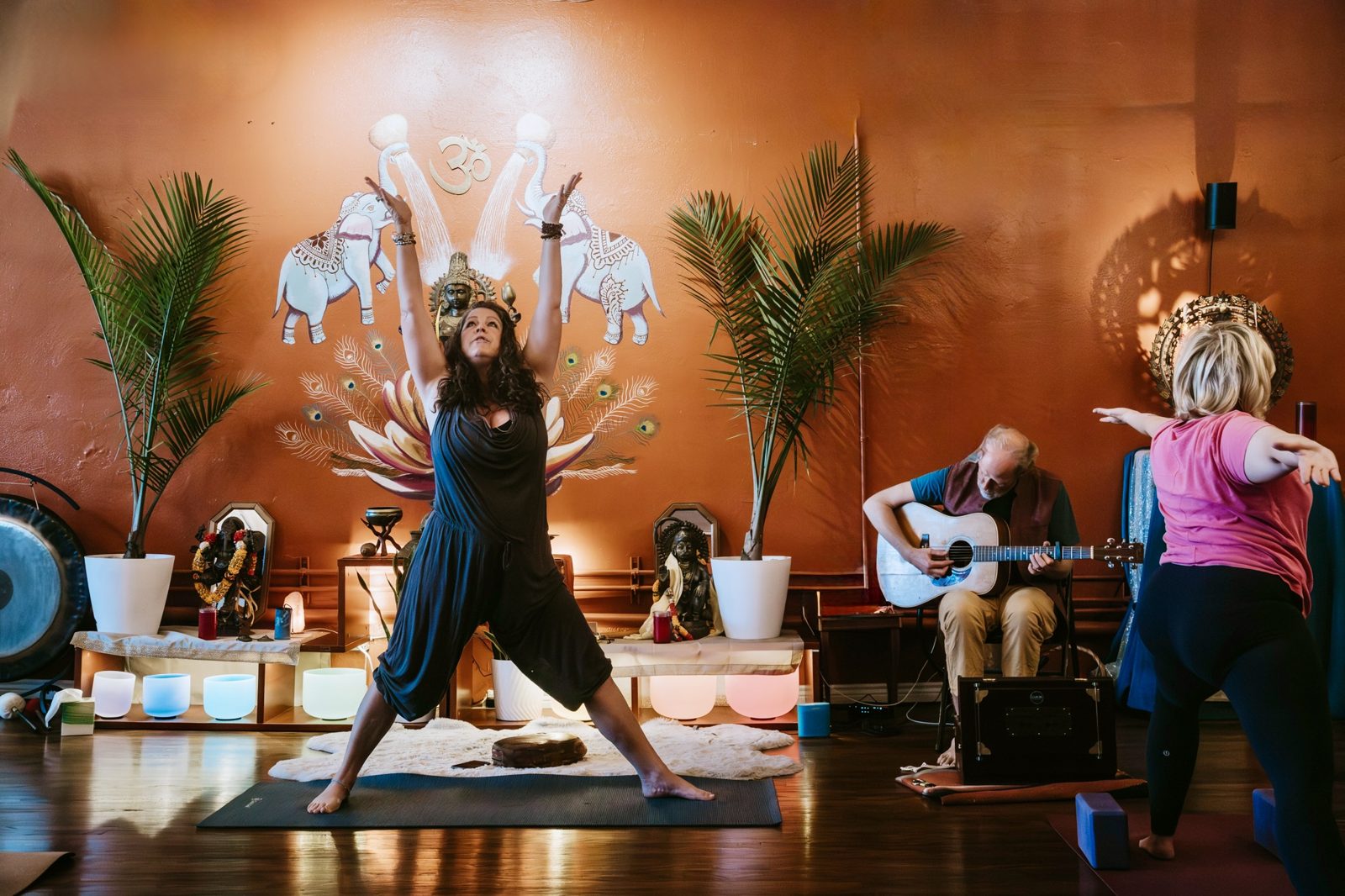 Studio yoga class with live music at Karma Yoga Center, Denver