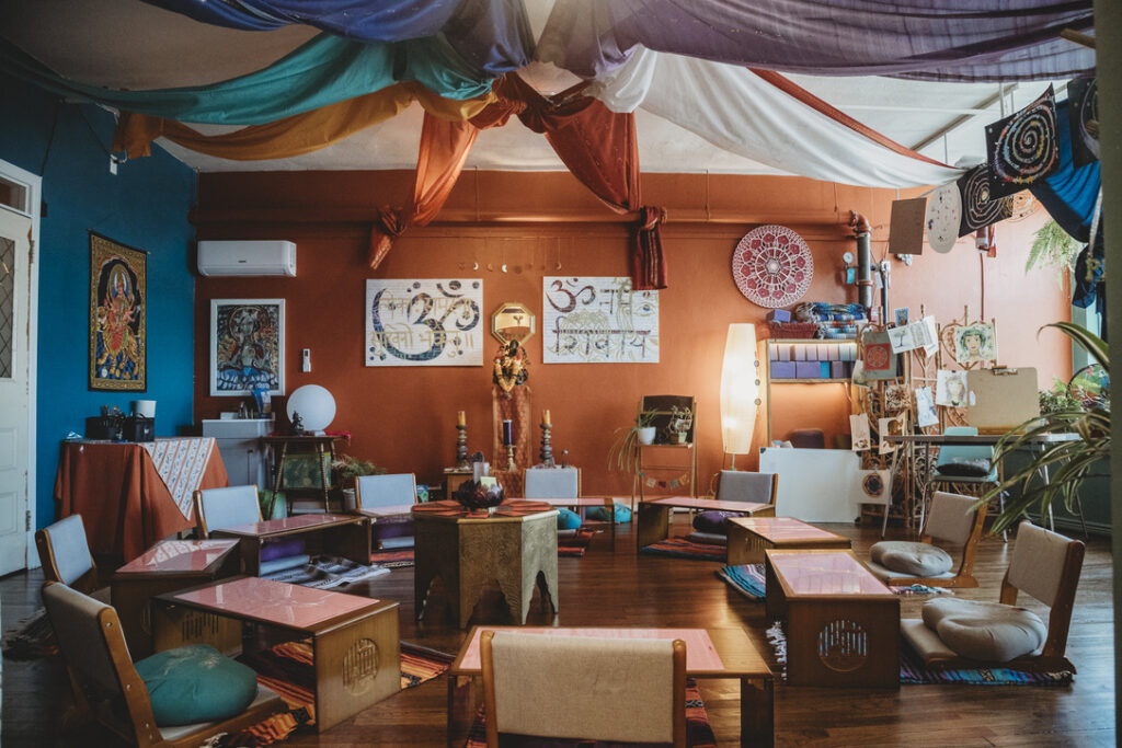 Teacher training, workshop, and art room with low tables and floor cushions at Karma Yoga Center