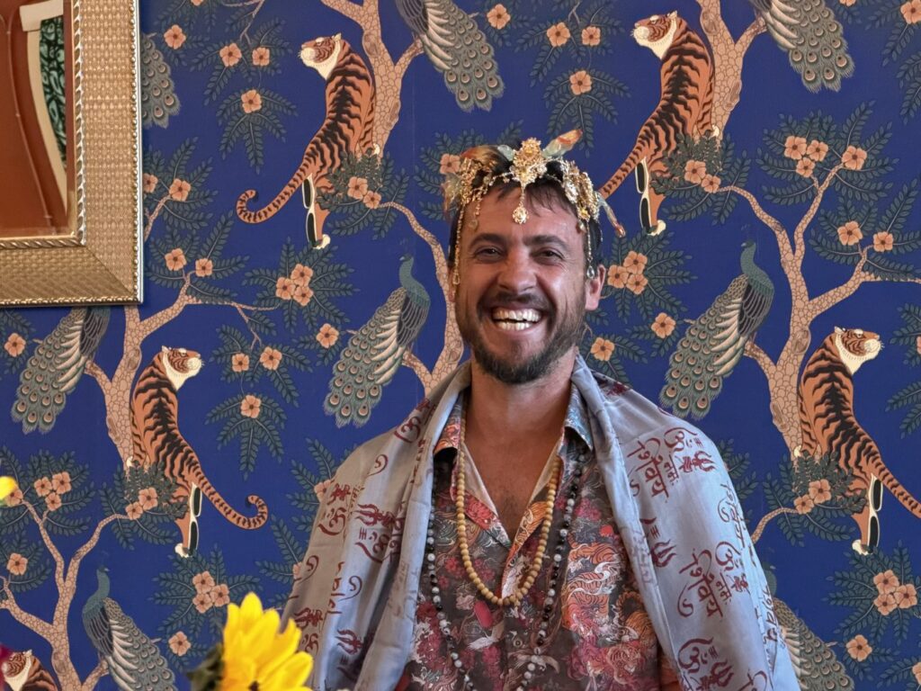 Joyful yoga teacher training graduate celebrating at Karma Yoga Center