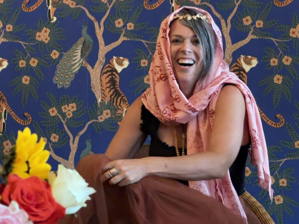 Joyful yoga teacher training graduate at Karma Yoga Center