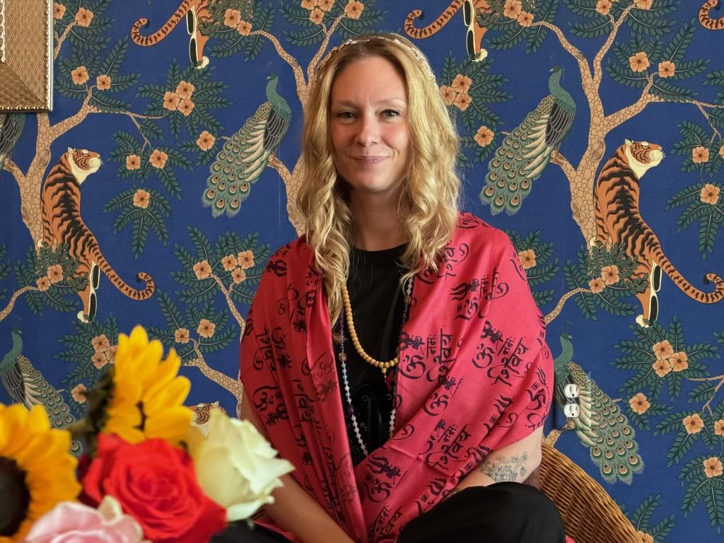 Smiling yoga teacher training graduate at Karma Yoga Center in Denver