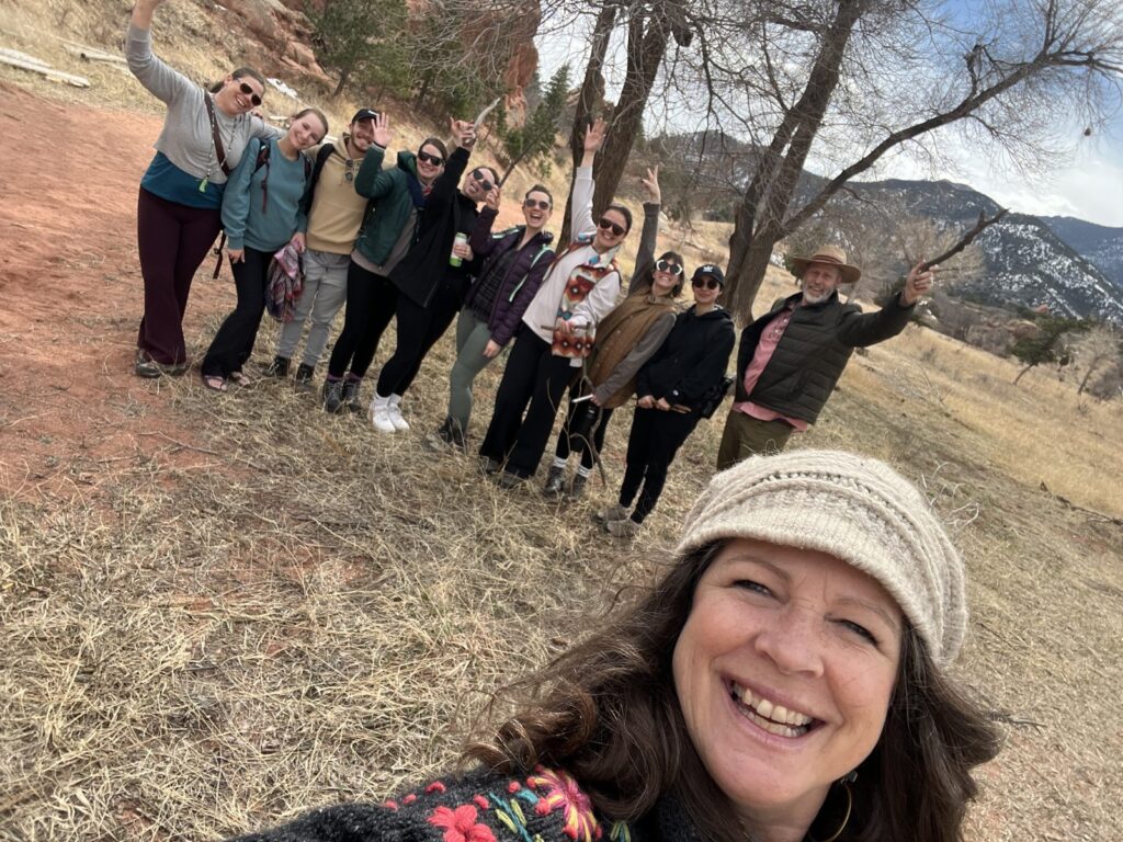 Teacher training students celebrating outdoors at the Colorado mountain retreat